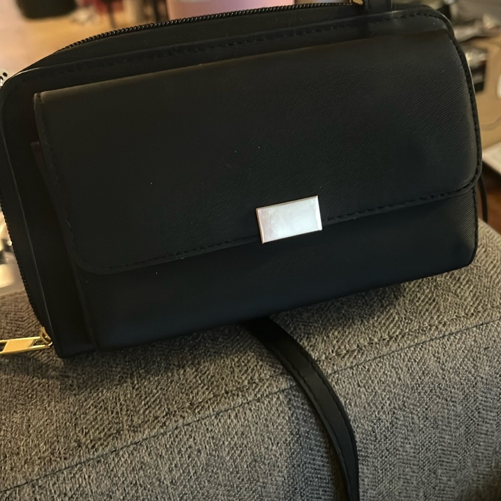 Never used black purse. Lots of compartments.